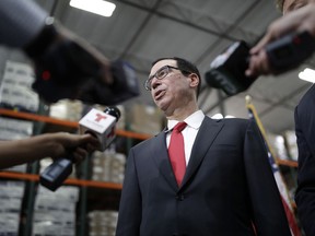 FILE - In this Monday, Aug. 28, 2017, file photo, Treasury Secretary Steven Mnuchin speaks at a news conference in Las Vegas. The Treasury Department says that concerns about secure communications with government agencies is what prompted Mnuchin to inquire about using a government plane for his European honeymoon in August. In a statement, the department says the request for a government plane was withdrawn because a "secure communications option was identified" without the use of a government plane. (AP Photo/John Locher, File)