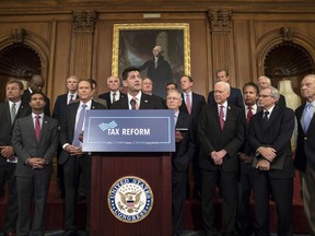 FILE - In this Wednesday, Sept. 27, 2017, file photo, Speaker of the House Paul Ryan, R-Wis., at podium, speaks about the Republicans' proposed rewrite of the tax code for individuals and corporations, at the Capitol in Washington. President Donald Trump and congressional Republicans are writing a far-reaching, $5.8 trillion plan they say would simplify the tax system and nearly double the standard deduction used by most Americans. (AP Photo/J. Scott Applewhite, File)