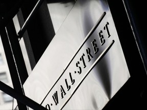 FILE - This July 15, 2013, file photo, shows a sign for Wall Street outside the New York Stock Exchange. U.S. stock indexes veered slightly lower in early trading Thursday, Sept. 21, 2017, as investors sized up the latest batch of company earnings and deal news. (AP Photo/Mark Lennihan, File)