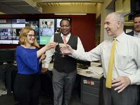 FILE - In this April 10, 2017, file photo, New York Daily News reporter Sarah Ryley, left, celebrates with News Editor Robert Moore, center, and Editor In Chief Arthur Browne in New York, after The New York Daily News and ProPublica won the 2017 Pulitzer Prize in public service. Newspaper publisher Tronc has acquired the Daily News, a storied New York tabloid newspaper that has been buffeted by the changing media environment, announced Monday, Sept. 4, 2017. (Jefferson Siegel/The Daily News via AP, File)