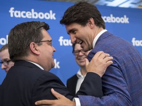 Prime Minister Justin Trudeau, right, shares a laugh with Montreal Mayor Denis Coderre during the Facebook launching of an artificial intelligence research lab Friday, September 15, 2017 in Montreal. THE CANADIAN PRESS/Paul Chiasson
