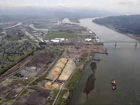 FILE- This May 12, 2005, file photo, shows the port of Longview on the Columbia River at Longview, Wash. The Department of Ecology said Tuesday, Sept. 26, 2017, it rejected a water quality permit that Millennium Bulk Terminals wanted because the proposed facility near Longview in southwest Washington state would have caused "significant and unavoidable harm" to the environment. (AP Photo/Elaine Thompson, File)