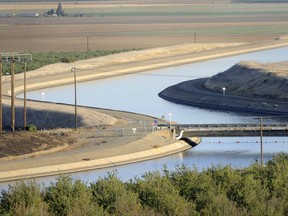 FILE- In this Oct. 2, 2009 file photo, in California's Westland Water District of the Central Valley, canals carry water to southern California. With no groups stepping forward to bankroll Gov. Jerry Brown's ambitious plan to re-engineer California's north-south water delivery system, state and local officials now say millions of California water customers will have to spend billions funding the state's biggest water project in decades. (AP Photo/Russel A. Daniels, File)