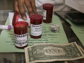 FILE - In this May 14, 2013, file photo, medical marijuana prescription vials are filled at a medical marijuana dispensary in Venice, Calif. Recreational marijuana use becomes legal in California in 2018, and one of the things to blossom in the emerging industry isn't green and leafy, it's government jobs. (AP Photo/Damian Dovarganes, File)