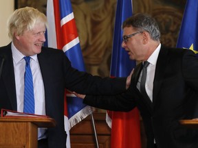 Great Britain's Foreign Secretary Boris Johnson, left, and Czech Republic's Foreign Minister Lubomir Zaoralek, right, hold a press conference in Prague, Czech Republic, Monday, Sept. 25, 2017. (AP Photo/Petr David Josek)