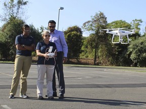 In this Aug. 30, 2017 photo, Laura Shell, center, a Travelers catastrophe claims specialist from Lexington, Va., trains to become a certified drone operator at the insurance company's Windsor, Conn., training center. The industry is using drones to help assess damage in Texas from Hurricane Harvey. (AP Photo/Pat Eaton-Robb)