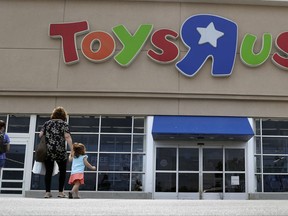 In this Tuesday, Sept. 19, 2017, photo, shoppers walk into a Toys R Us store, in San Antonio. Toys R Us may have filed for Chapter 11 bankruptcy protection this week, but the toy chain is revving up its holiday hiring. The Wayne, New Jersey-based retailer plans to hire more than 12,500 for the top six markets, which include Boston and New York. (AP Photo/Eric Gay)