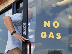 A customer walks into an Exxon filling station and convenience store location where a sign on the door reads, "No Gas," Thursday, Aug. 31, 2017, in Bedford, Texas. It's getting harder to fill gas tanks in parts of Texas where some stations are out of fuel and pump costs are spiking. A major gasoline pipeline shuttered due to Harvey may be able to resume shipping fuel from the Houston area by Sunday, which could ease gasoline shortages across the southern U.S. (AP Photo/Tony Gutierrez)