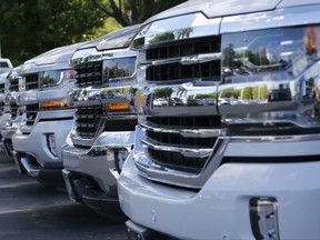 In this Wednesday, April 26, 2017, photo, trucks are lined up in the lot at a dealership in Richmond, Va. Consumers cut back on their shopping in August by the largest amount in six months as a big drop in auto sales offset gains in other areas, according to information released Friday, Sept. 15, 2017, by the Commerce Department. (AP Photo/Steve Helber)