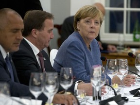 German Chancellor Angela Merkel, right, sits with Swedish Prime Minister Stefan Lofven, center, and Bulgarian Prime Minister Bokyo Borisov during an informal dinner ahead of an EU Digital Summit in Tallinn, Estonia on Thursday, Sept. 28, 2017. The European Union will be looking beyond the impending breakup with Britain at how to build a common future at 27 during their two-day summit meeting starting late Thursday. (AP Photo/Virginia Mayo, Pool)
