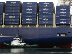 In this Monday, Feb. 29, 2016, photo, a Foss Maritime tugboat nudges the container ship CMA CGM Benjamin Franklin into place at Seattle's Terminal 18. On Tuesday, Sept. 19, 2017, the Commerce Department reports on the U.S. current account trade deficit for the April-June quarter. The current account is the broadest trade measure, covering goods, services and investment flows. (Genna Martin/seattlepi.com via AP)