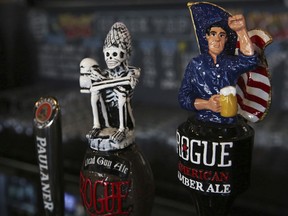 This Sunday, Sept. 10, 2017 photo, shows draft tap handles for beers from Newport, Oregon's Rogue Ales brewery, at the Black Tap restaurant in Dubai, United Arab Emirates. Dubai long has been known for its clubbing scene and cocktail bars, but there's a new thirst for craft beer. New businesses are springing up and exotic brews are replacing the country's standard lagers. (AP Photo/Jon Gambrell)