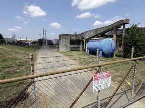 A gate at the U.S. Oil Recovery Superfund site is shown Thursday, Sept. 14, 2017, in Pasadena, Texas, where three tanks once used to store toxic waste were flooded during Hurricane Harvey. The Environmental Protection Agency says it has found no evidence that toxins washed off the site, but is still assessing damage.  (AP Photo)