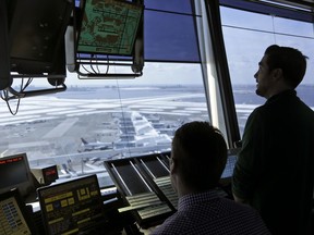In this March 16, 2017 photo, air traffic controllers work in the tower at John F. Kennedy International Airport in New York. The Senate has passed a bill that would avoid a partial shutdown of federal aviation programs and provide tax relief for hurricane victims.  (AP Photo/Seth Wenig)