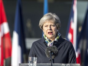 British Prime Minister Theresa May speaks to the NATO Battle Group troops at the Tapa military base, about 90 kilometers (56 miles) west of Tallinn, Estonia, Friday, Sept. 29, 2017. May is guaranteeing Britain's security commitment to the other 27 European Union leaders even if the nation is leaving the bloc and divorce proceedings are struggling along. (AP Photo/Marko Mumm)