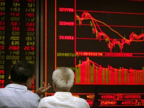 Chinese investors monitor stock prices at a brokerage house in Beijing, Tuesday, Sept. 26, 2017. Asian stocks were little changed Tuesday as investors watched U.S.-North Korean tensions after a decline in tech shares dragged down Wall Street. (AP Photo/Mark Schiefelbein)