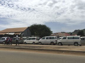 In this photo of Sunday Oct. 1, 2017, cars wait in line for days at a petrol station in South Sudan's capital of Juba. The oil rich country of South Sudan is suffering one of the worst fuel shortages in years, with many people waiting for days at gas stations in order to get fuel. It is a cruel irony that ninety-eight percent of South Sudan's economy comes from oil, but the country faces one of its worst fuel crises since civil war broke out in 2013. (AP Photo/Sam Mednick)