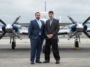 Chris Nowrouzi (left) and David Nissan (right), both CEO of FlyGTA, pose for a portrait in front of one of their company planes at Billy Bishop Toronto City Airport in Toronto.