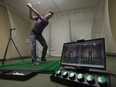 Certified personal coach Joe DiFlorio demonstrates how electronics can be used to help golfers in Ottawa on Friday, October 6, 2017. The secret, golfer Ben Hogan famously declared, is in the dirt. But on Dave Druken's high-tech practice range, there's not a speck of the stuff.In truth, Golftec's indoor teaching facilities are more laboratory than lesson tee: sensors and video cameras capture the swing in minute detail, while screens around the room display what's happening from every conceivable angle. THE CANADIAN PRESS/Adrian Wyld