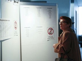 A voter checks a board on where to vote, at the Reykjavik City Hall polling station, during the general election in Reykjavik, Iceland, Saturday Oct. 28, 2017.  Icelanders are voting for the third time in four years as the nation tries to shake off the latest political crisis on an island that has been roiled by divisions since its economy was ravaged by the global financial crisis in 2008. (AP Photo/Brynjar Gunnarsson)