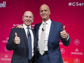 Bombardier President and CEO Alain Bellemare (left) and Airbus CEO Tom Enders gesture during a business meeting in Montreal on October 20, 2017