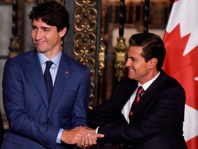 Canada's Prime Minister Justin Trudeau, left, and Mexican President Enrique Pena Nieto shake hands at the presidential palace in Mexico City last Thursday.