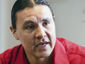 FILE - In this Feb. 6, 2014, file photo, Chase Iron Eyes, an attorney and American Indian activist on the Standing Rock Reservation, is seen in Fort Yates, N.D. Iron Eyes, who is accused of inciting a riot during protests against the Dakota Access pipeline says he'll seek to present a "necessity defense." That's justifying a crime by arguing it prevented a greater harm. Iron Eyes has pleaded not guilty to inciting a riot and criminal trespass. He could face more than five years in prison if convicted at trial in February 2018. (AP Photo/Kevin Cederstrom, File)