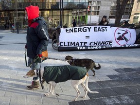 Members of Stop Energy East Halifax protest outside the library in Halifax on Monday, Jan. 26, 2015. TransCanada says it's cancelling plans for the Energy East pipeline and Eastern Mainline projects. THE CANADIAN PRESS/Andrew Vaughan