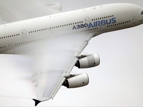 Vapour forms across the wings of an Airbus A380 as it performs a demonstration flight at the Paris Air Show, Le Bourget airport, north of Paris on June 18, 2015. The federal Liberals have promised to build in safeguards to make sure this week's stunning deal between Bombardier and European rival Airbus helps, and doesn't hurt, Canada's aerospace industry.Airbus wants to buy a majority stake in Bombardier's CSeries commercial planes, whose future has been in question after U.S. officials proposed a hefty 300 per cent import duty on the jet program. THE CANADIAN PRESS/AP, Francois Mori