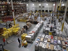 In this Aug. 3, 2017, photo, workers prepare to move products at an Amazon fulfillment center in Baltimore. The e-commerce retail giant Amazon is expanding to Alberta, building a distribution centre just outside Calgary city limits that will create 750 full-time jobs. THE CANADIAN PRESS/AP/Patrick Semansky