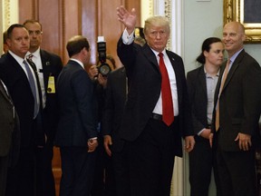 President Donald Trump waves to reporters after a lunch with Republican senator at the U.S. Capitol Tuesday, Oct. 24, 2017, in Washington. (AP Photo/Evan Vucci)