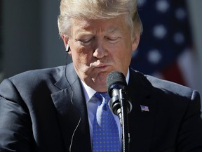 President Donald Trump looks down at his podium during a news conference with Greek Prime Minister Alexis Tsipras in the Rose Garden of the White House in Washington, Tuesday, Oct. 17, 2017. (AP Photo/Pablo Martinez Monsivais)