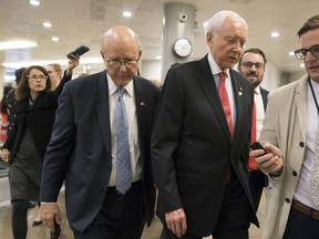 Sen.Pat Roberts, R-Kan., a member of the Senate Finance Committee, walks with Sen. Orrin Hatch, R-Utah, the panel's chairman, during votes at the Capitol in Washington, Thursday, Oct. 19, 2017. (AP Photo/J. Scott Applewhite)