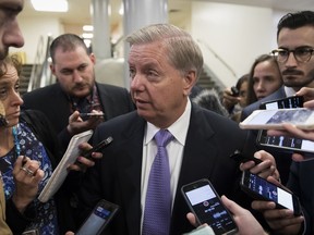 Sen. Lindsey Graham, R-S.C., chairman of the Senate Subcommittee on Crime and Terrorism, is questioned by reporters during votes, at the Capitol in Washington, Thursday, Oct. 19, 2017. (AP Photo/J. Scott Applewhite)