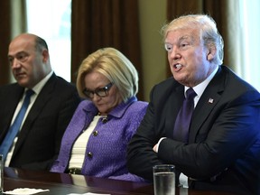 President Donald Trump, right, sitting next to Sen. Claire McCaskill, D-Mo., center, and White House chief economic director Gary Cohn, left, speaks during a meeting with members of the Senate Finance Committee and members of the President's economic team in the Cabinet Room of the White House in Washington, Wednesday, Oct. 18, 2017. (AP Photo/Susan Walsh)