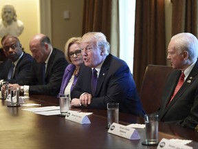 President Donald Trump, center, speaks during a meeting with members of the Senate Finance Committee and members of the President's economic team in the Cabinet Room of the White House in Washington, Wednesday, Oct. 18, 2017. Trump is joined by, from left, Sen. Tim Scott, R-S.C., White House chief economic director Gary Cohn, Sen. Claire McCaskill, D-Mo., and Senate Finance Committee Chairman Sen. Orrin Hatch, R-Utah. (AP Photo/Susan Walsh)