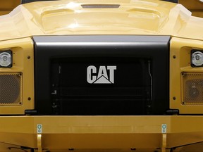 This Monday, July 24, 2017, photo shows the Caterpillar logo on the front of a Caterpillar 725C end dump truck at a dealer in Miami. Caterpillar, Inc. reports earnings Tuesday, Oct. 24, 2017. (AP Photo/Alan Diaz)