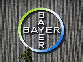 FILE - In this May 23, 2016, file photo the Bayer AG corporate logo is displayed on a building of the German drug and chemicals company in Berlin, Germany. German pharmaceutical giant Bayer AG said Friday, Oct. 13, 2017 it's reached a 5.9 billion euro (US$7 billion) agreement to sell businesses from its Crop Science unit to German chemical company BASF to alleviate regulatory concerns over its planned acquisition of American seed and weed-killer company Monsanto Co. (AP Photo/Markus Schreiber, file)