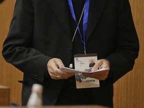 Vatican Secretary of State Cardinal Pietro Parolin prepares to speak at the Gregorian University in Rome, Tuesday, Oct. 3, 2017. The Vatican secretary of state urged law enforcement agencies, governments and social networking sites on Tuesday to take responsibility to protect children from online sexual abuse and exploitation, even as one of his diplomats is caught up in an international child porn investigation. (AP Photo/Andrew Medichini)