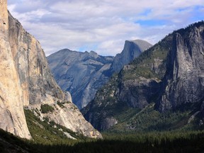 FILE - This Oct. 2, 2013, file photo, shows a view seen on the way to Glacier Point trail in the Yosemite National Park, Calif. The National Park Service is floating a proposal to increase entrance fees at 17 of its most popular sites next year. (AP Photo/Tammy Webber, File)
