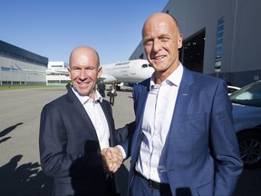 Airbus CEO Tom Enders, right, shakes hands with Bombardier CEO and President Alain Bellemare during a visit to Bombardier's Mirabel plant in Mirabel, Quebec, Friday, October 20, 2017. THE CANADIAN PRESS/Graham Hughes