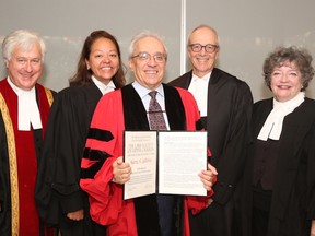 Justice Harry Laforme, centre, is presented with an honorary Doctor of Laws degree.