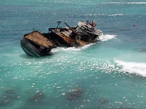 This undated photo provided by the U.S. Coast Guard shows the 79-foot fishing boat Pacific Paradise, aground off the beach at Waikiki in Honolulu on Oahu. The vesel that ran aground while transporting foreign fishermen to work in the commercial fishing industry in Hawaii is raising questions about the safety and conditions for foreign workers in this unique U.S. fishing fleet. (U.S. Coast Guard via AP)