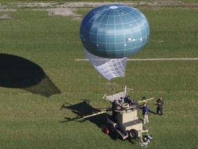 In this undated aerial photo provided by Drone Aviation Corp. shows a tethered balloon, called Winch Aerostat Small Platform, or WASP.  The U.S. Border Patrol is considering another type of surveillance balloon to spot illegal activity. It's part of an effort to see if more eyes in the sky translate to fewer illegal border crossings.  (Drone Aviation Corp. via AP)