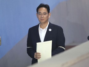 Lee Jae-yong, vice chairman of Samsung Electronics, arrives at the Seoul Central District Court for a hearing in Seoul, South Korea, Thursday, Oct. 12, 2017. Prosecutors are citing a past ruling on a North Korean spy case as one reason why Samsung's billionaire heir deserves a lengthy prison term for his conviction on bribery charges. The prosecutors and Samsung lawyers sparred Thursday during a first hearing by the appeals court on the effort by Lee to have his five-year prison sentence overturned. (AP Photo/Lee Jin-man)
