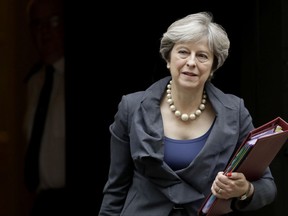 FILE - In this file photo dated Wednesday, Oct. 11, 2017, British Prime Minister Theresa May leaves 10 Downing Street in London.   Theresa May will have a dinner meeting in Brussels with senior European Union officials, European Commission President Jean-Claude Juncker and chief negotiator Michel Barnier on Monday Oct. 16, 2017, in hopes of reinvigorating stalled negotiations on Britain's Brexit departure from the European Union.(AP Photo/Matt Dunham, FILE)