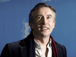 FILE - This is a March 10, 2017 file photo of British actor and comedian  Steve Coogan poses for the photographers during a photo call for the film 'The Dinner' at the 2017 Berlinale Film Festival in Berlin, Germany. Coogan has received financial damages and an apology from the Mirror Group Newspapers in the settlement of a long-running phone hacking case. Coogan said outside London's High Court Tuesday Oct. 3, 2017, that it was "six-figure" sum. (AP Photo/Markus Schreiber/File)