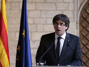 FILE - In this file photo dated Thursday Oct. 26, 2017, Catalan President Carles Puigdemont makes a statement at the Palau Generalitat in Barcelona, Spain. According to the office of a Catalan member of the European Parliament, it is confirmed Monday Oct. 30, 2017, that ousted Catalan President Carles Puigdemont has arrived in Brussels.(AP Photo/Emilio Morenatti, FILE)