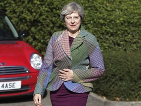 Britain's Prime Minister Theresa May arrives for charity coffee event in Reading, England, where she responded to claims of a plot involving Conservative Party Members of Parliament to oust her from Number 10, saying she is providing "calm leadership" with the "full support" of her cabinet Friday Oct. 6, 2017. (Yui Mok/PA via AP)