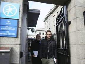 Max Schrems, front right, leaves the High Court in Dublin, Ireland, Tuesday Oct. 3, 2017, as the legal case about social media transfer of personal data between international jurisdictions has been referred to Europe's highest court.  Austrian lawyer and campaigner Max Schrems claims his privacy rights as an EU citizen have been breached through the transfer of his data by Facebook Ireland to US parent company Facebook Inc. (Brian Lawless/PA via AP)